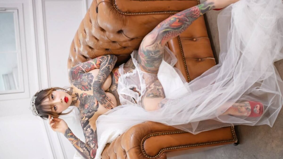 A cute tattooed Asian cosplayer with big tits during sex